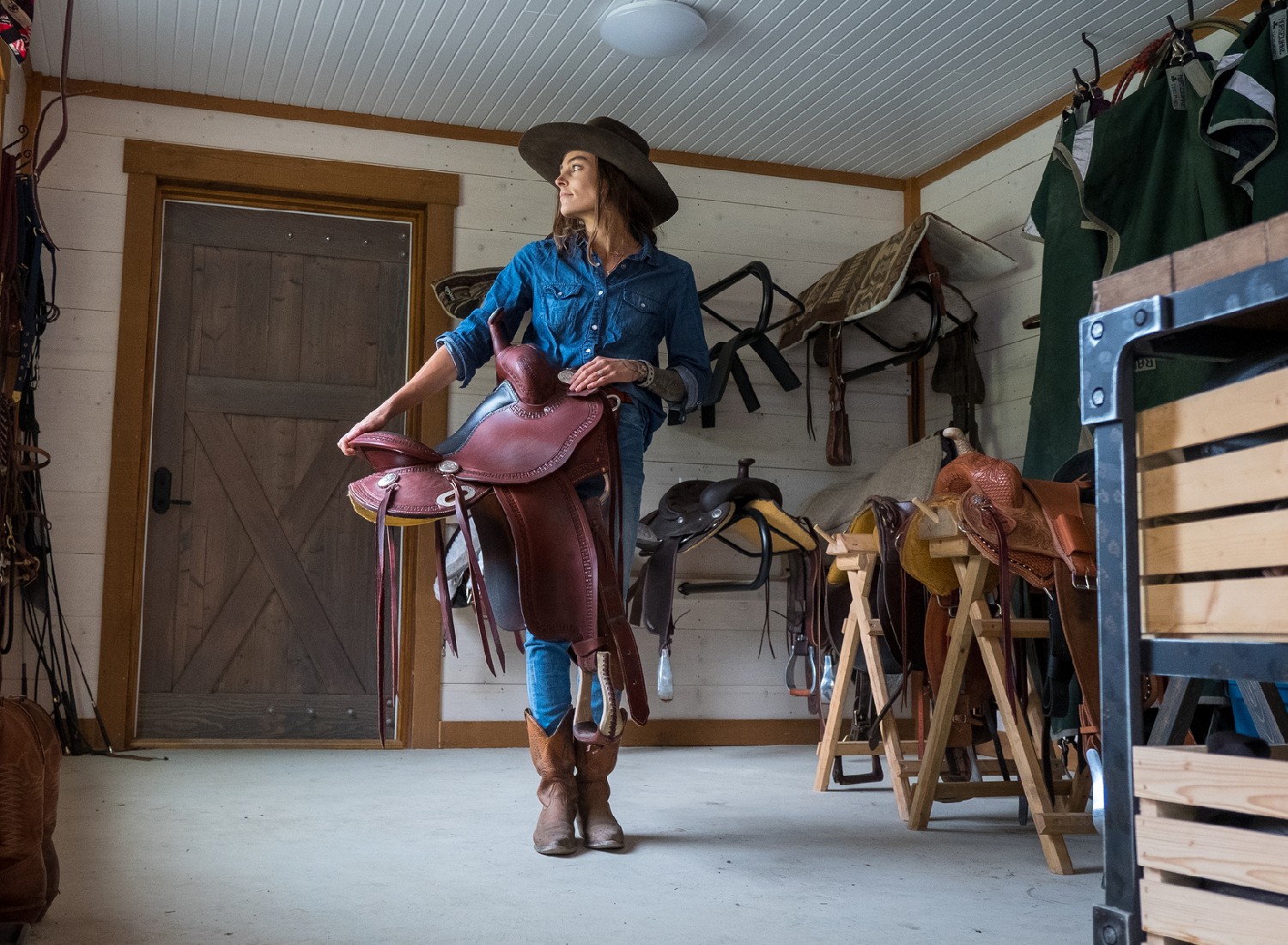 Female farmer in a tacking room